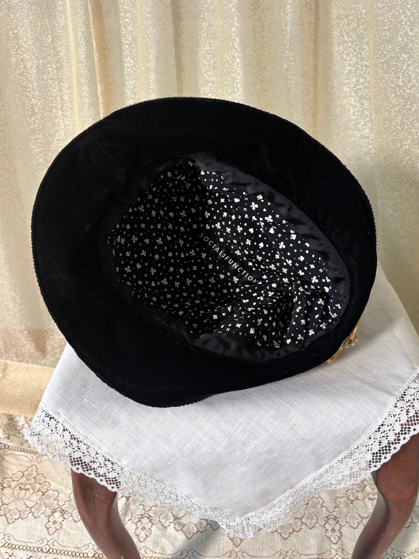 Black velvet hat with brooch
